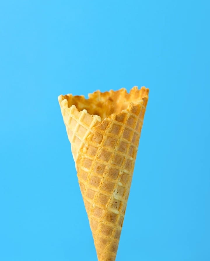 empty ice cream cone on blue background